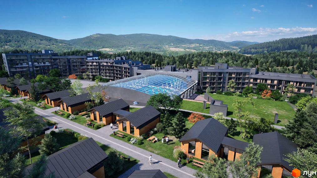 Апарт-комплекс PHOENIX MEDICAL RESORT з дерев'яними будиночками та великим басейном під скляним дахом. Територія комплексу оточена зеленими пагорбами та лісом.