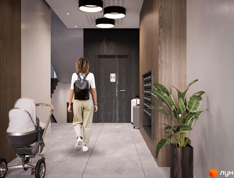 Вхідна група житлового комплексу Героїв Крут з коляскою та валізою. Сучасний дизайн інтер'єру з дерев'яними елементами та рослинами.