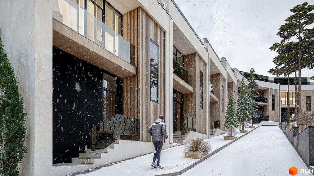 Фасади ZAGRAVA Villas & Residence з дерев'яних панелей та світлого бетону, з балконами. Засніжена прибудинкова територія з хвойними деревами.