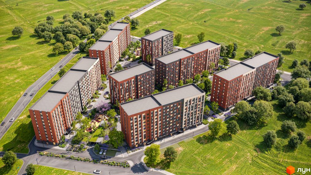 Житловий комплекс Happy 7: аерофотознімок багатоповерхових будинків з фасадами цегляного та сірого кольорів, оточених зеленими насадженнями та дорогами.