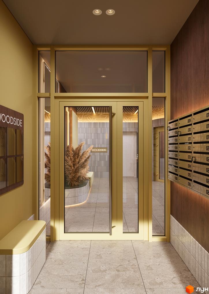 Вхідна група житлового комплексу Woodside з золотистими дверима, поштовими скриньками та декоративними рослинами у вестибюлі.