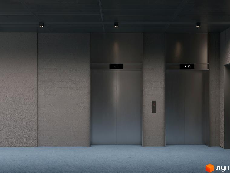 Ліфтовий хол Circle hotel&apartments: два металеві ліфти, стіни з бетону, синє килимове покриття. Вбудовані світильники освітлюють простір.