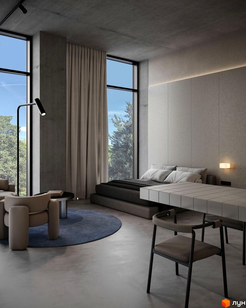 Вид з вікна апартаментів Circle hotel&apartments на зелену зону. Простора кімната з бетонними стінами, великими вікнами та меблями.