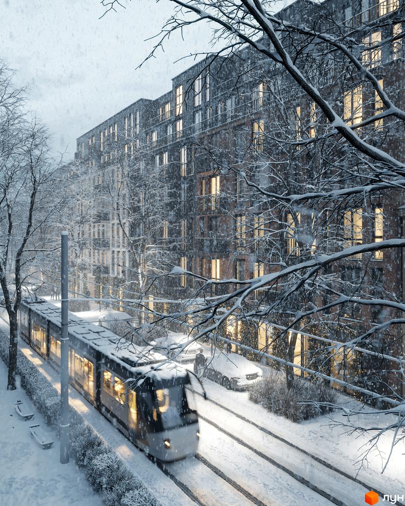 Житловий комплекс Avalon Yard взимку: багатоповерхові будинки з цегляними фасадами та освітленими вікнами, засніжена прибудинкова територія з трамваєм.