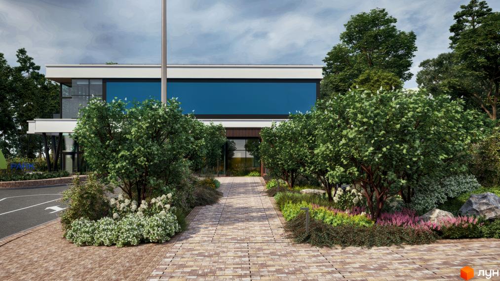 Житловий комплекс Gravity Park зі світлим фасадом та синіми вікнами. Перед будинком вимощена доріжка та озеленена територія.