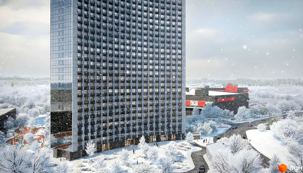 Багатоповерховий Житловий комплекс BEREG Residence зі скляним фасадом та численними балконами, оточений засніженим парком взимку.