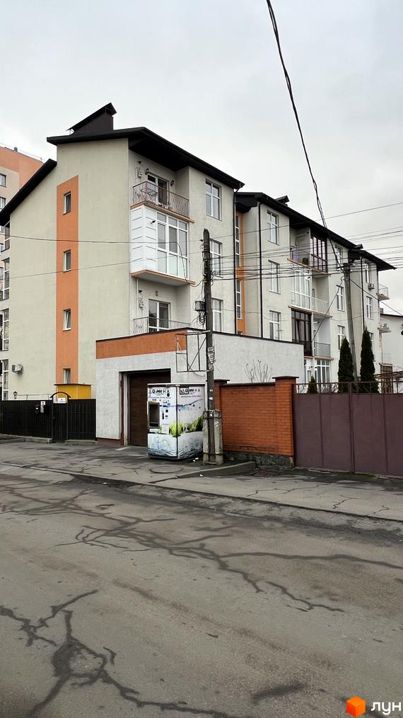 Житловий комплекс на вул. Заболотного, 20, з фасадом у світлих тонах та прибудинковою територією.