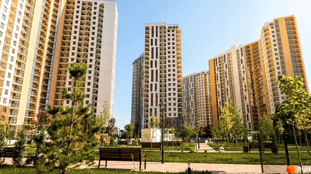 Житловий комплекс KADORR City з сучасними багатоповерхівками та облаштованою прибудинковою територією з зеленими насадженнями.