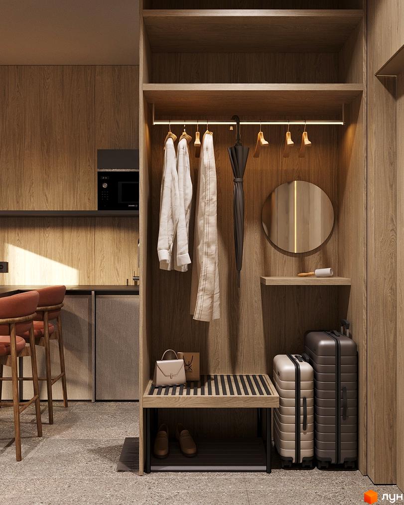 Сучасний інтер'єр прихожої з дерев'яними елементами, вішалкою для одягу та місцем для багажу.