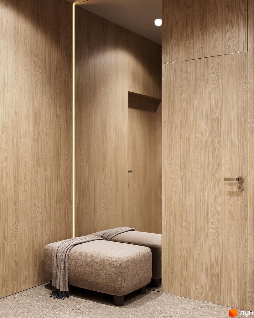 Сучасний інтер'єр житлового комплексу Logos Home Apartment з дерев'яними стінами та м'яким пуфом у передпокої.