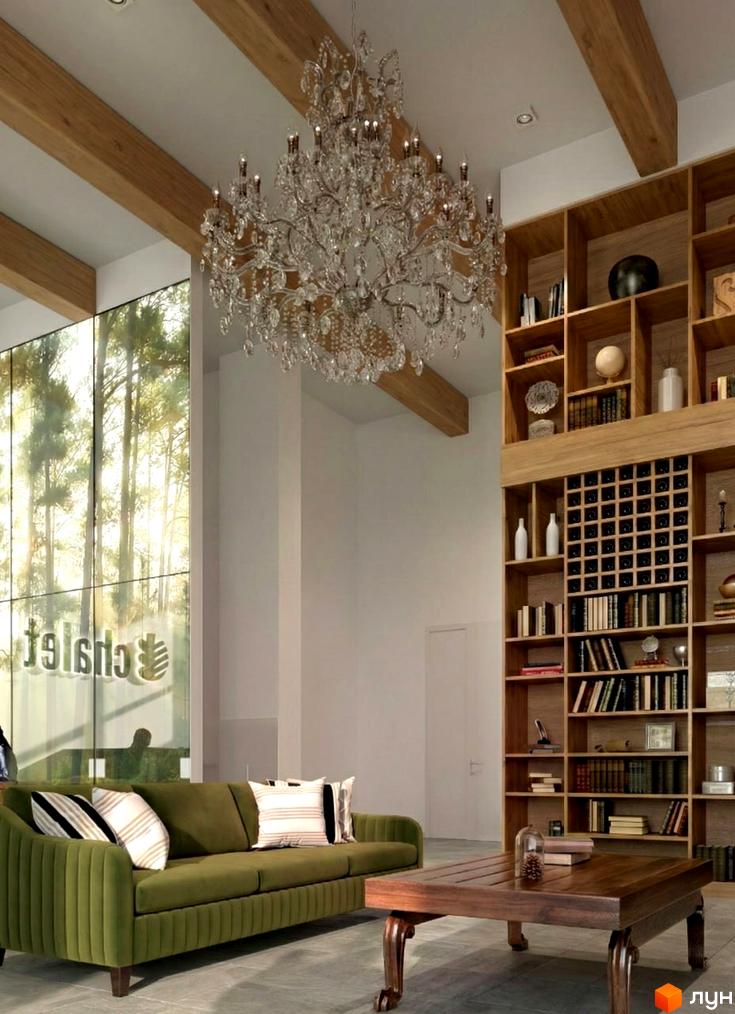 Інтер'єр житлового комплексу ЖК Chalet з зеленим диваном, дерев'яними стелями та книжковими полицями.