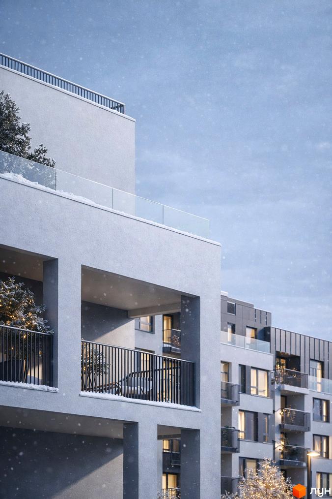 Зимовий вигляд Житлового комплексу Empatika: світлі фасади будівель з балконами, вкриті снігом. Навколо засніжені дерева з гірляндами.