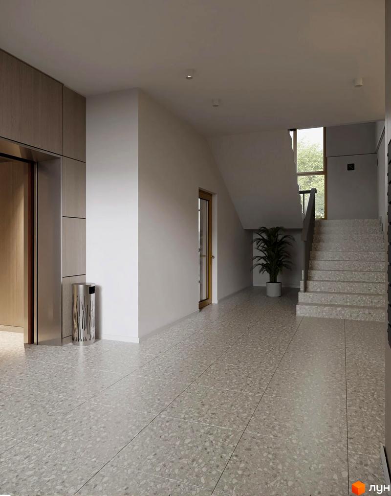 Внутрішній простір Житлового комплексу Lumen: світлий хол з ліфтом, сходами та великим вікном. Підлога викладена плиткою під терацо.