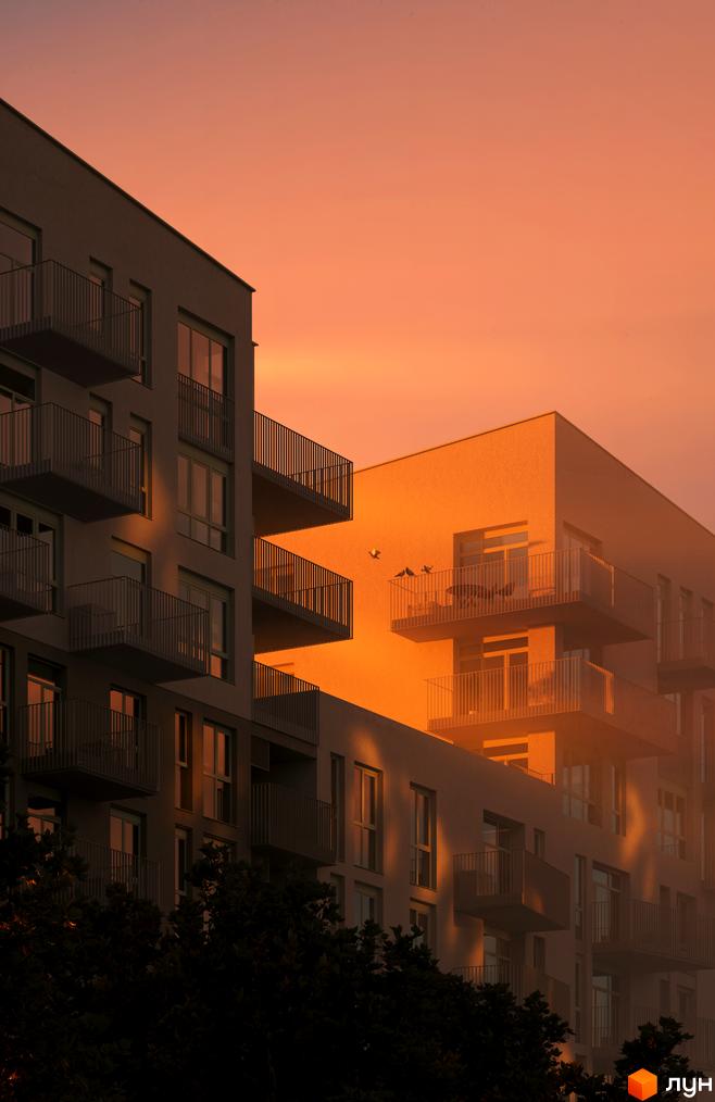 Житловий комплекс Avalon Yard з балконами на тлі помаранчевого неба на заході сонця. Сучасна архітектура новобудови.