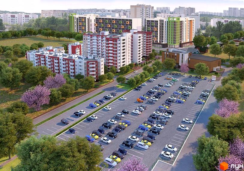 Житловий комплекс Сакура з багатоповерховими будинками біло-червоного та кольорового фасадів. Вид зверху на великий паркінг та зелені насадження з квітучими деревами.