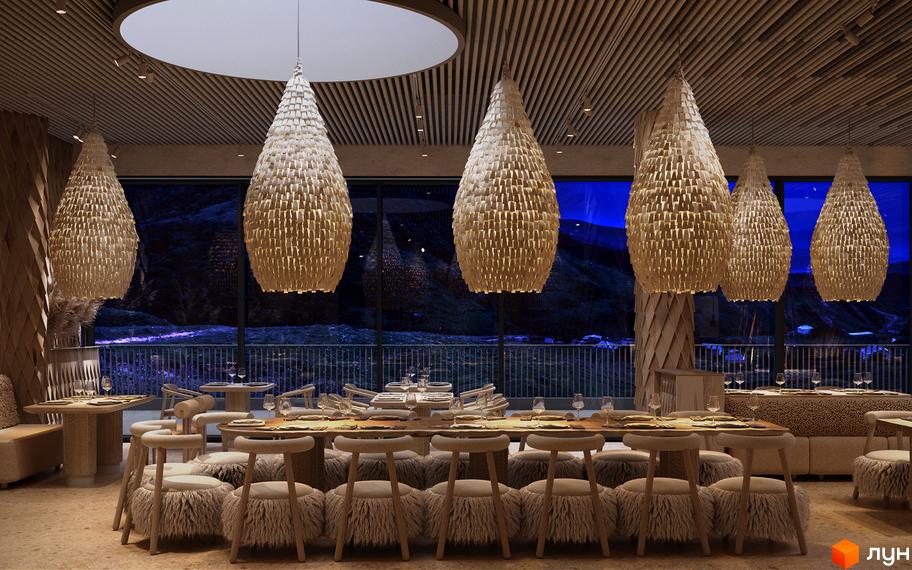 Ресторан Апарт-готелю IKON Resort з панорамними вікнами та видом на нічні гори, освітлений великими плетеними світильниками.