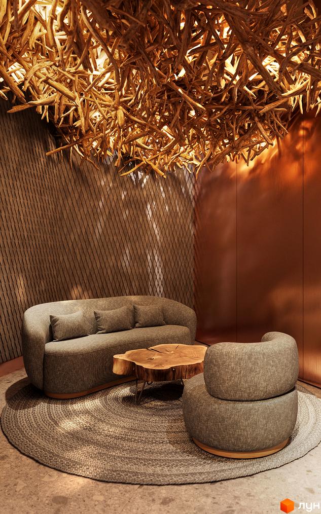 Апарт-готель IKON Resort: затишна зона відпочинку з диваном, кріслом та кавовим столиком з натурального дерева. Оригінальна люстра з гілок створює атмосферу.