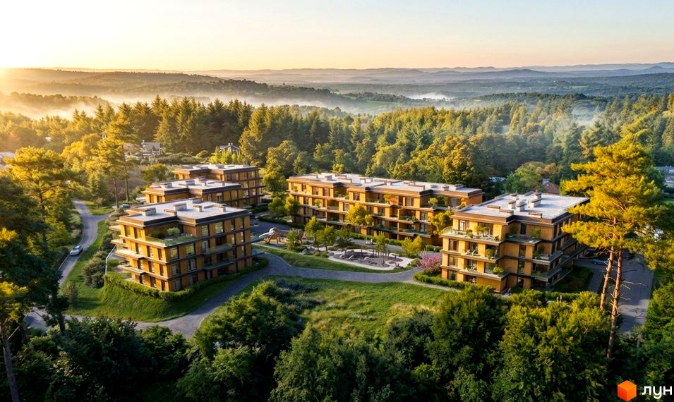 Житловий комплекс AURA: багатоповерхові будинки з дерев'яними фасадами та балконами, оточені зеленим лісом та пагорбами на світанку.