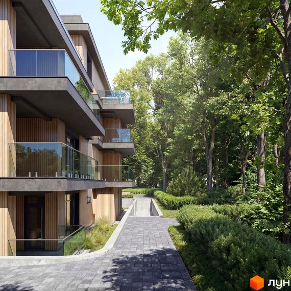 Житловий комплекс AURA з дерев'яним облицюванням та балконами зі скляними поручнями, поруч доріжка та багато зелені.