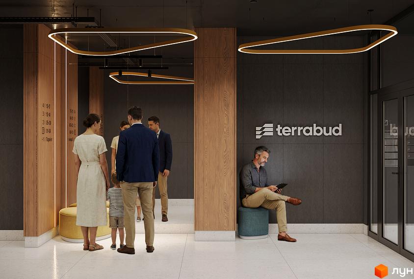 Лобі житлового комплексу AURA з елементами дерева та сучасними світильниками. Люди чекають на ліфт біля інформаційної дошки.