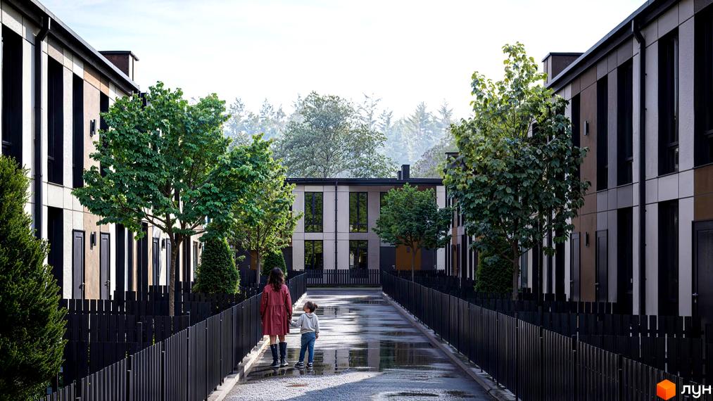 Таунхауси Емірати: фасади будинків з вертикальними елементами та чорними вікнами. Доглянута прибудинкова територія з деревами та чорним парканом.