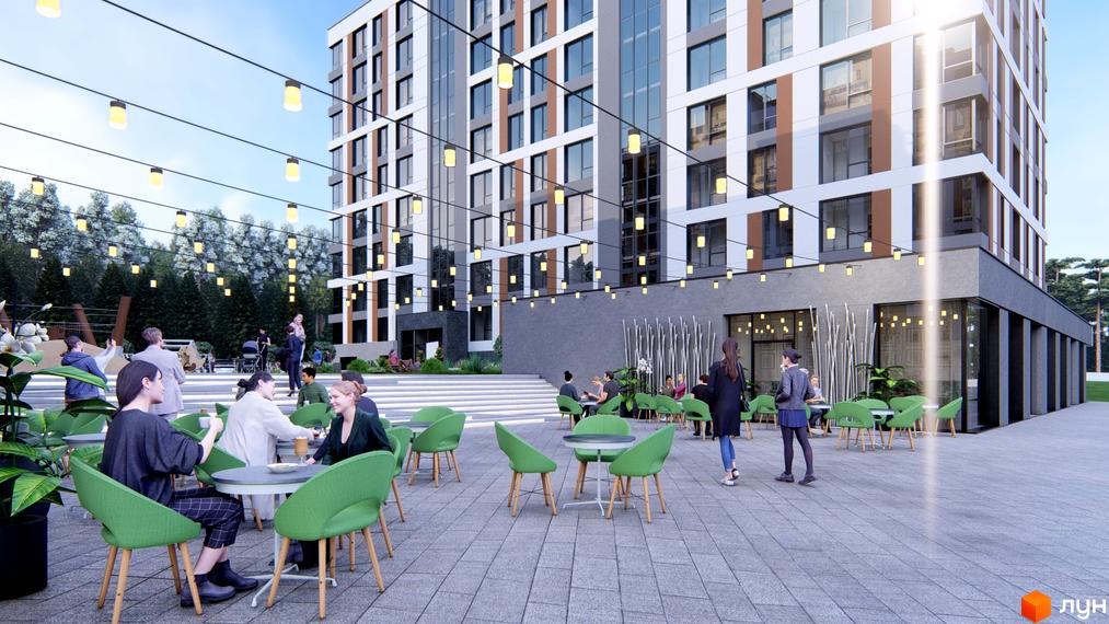 Багатоповерховий будинок Житлового комплексу Свій з білими, сірими та коричневими фасадами. Прибудинкова територія з кафе, зеленими стільцями, столами та гірляндами.