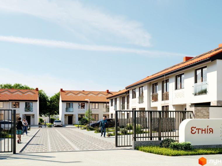 Котеджне містечко Етнія: білі будинки з червоними черепичними дахами та брукована вулиця з людьми та автомобілями. Огороджена територія з воротами та вивіскою.