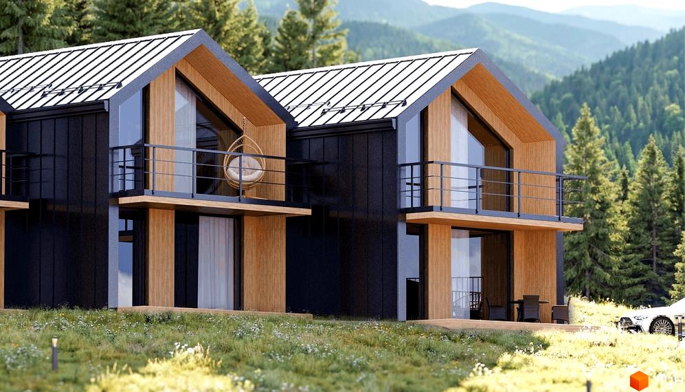 Котеджне містечко КМ Теплий: двоповерхові будинки з чорними фасадами, дерев'яними вставками та металевими дахами на тлі гірського лісу. Прибудинкова територія вкрита травою з квітами.