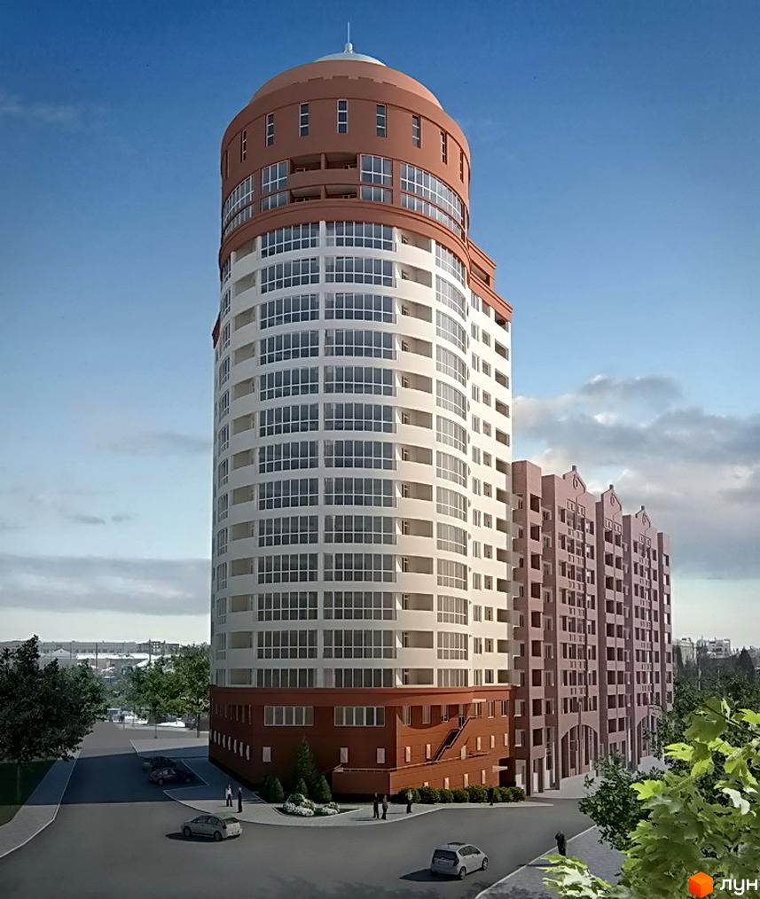 Житловий комплекс Чкаловський: кругла багатоповерхівка з коричневим низом та куполом, білими фасадами, поруч будівля з гостроверхими дахами. Територія з дорогою та зеленню.