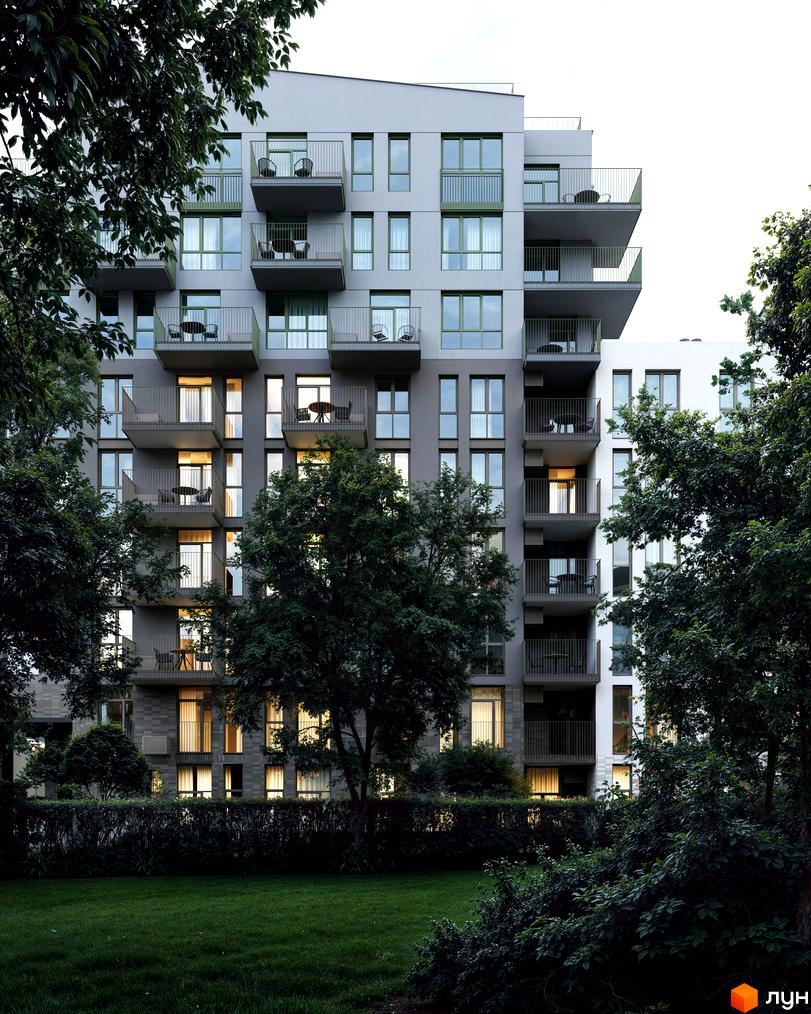 Фасад Житлового комплексу Avalon Yard з багатоповерховою забудовою, балконами та освітленими вікнами. Навколо зелені дерева та доглянутий газон.