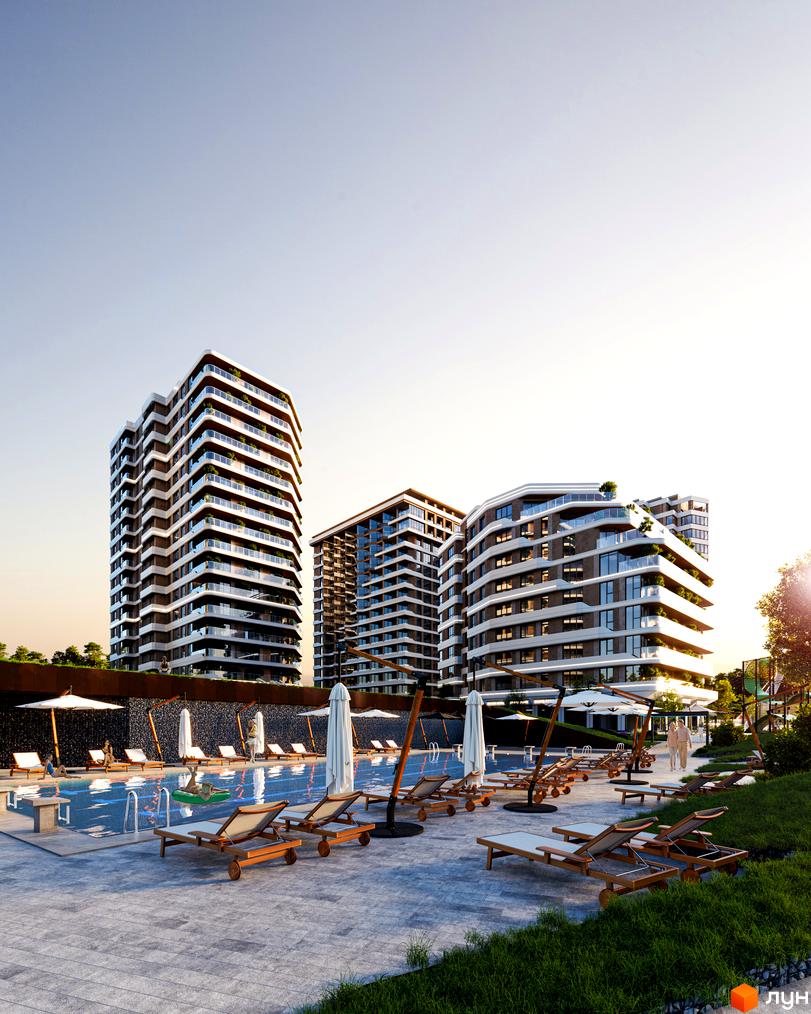 Житловий комплекс River Port з високими будинками, що мають світлі та темні фасади, та закруглені балкони. На передньому плані видно басейн з шезлонгами та парасольками.