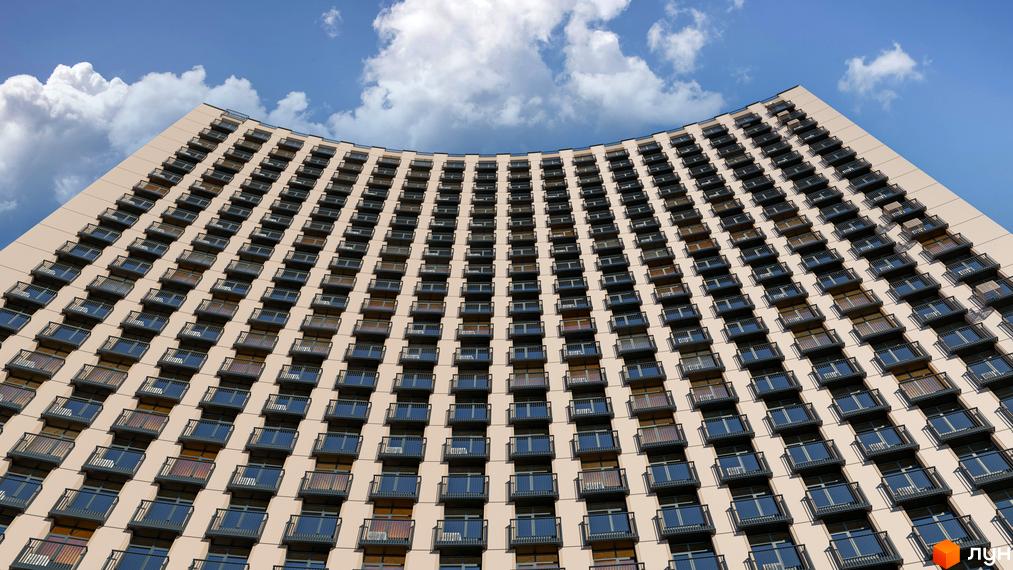 Житловий комплекс BEREG Residence: висотна вигнута будівля світлого кольору з численними балконами під блакитним небом.