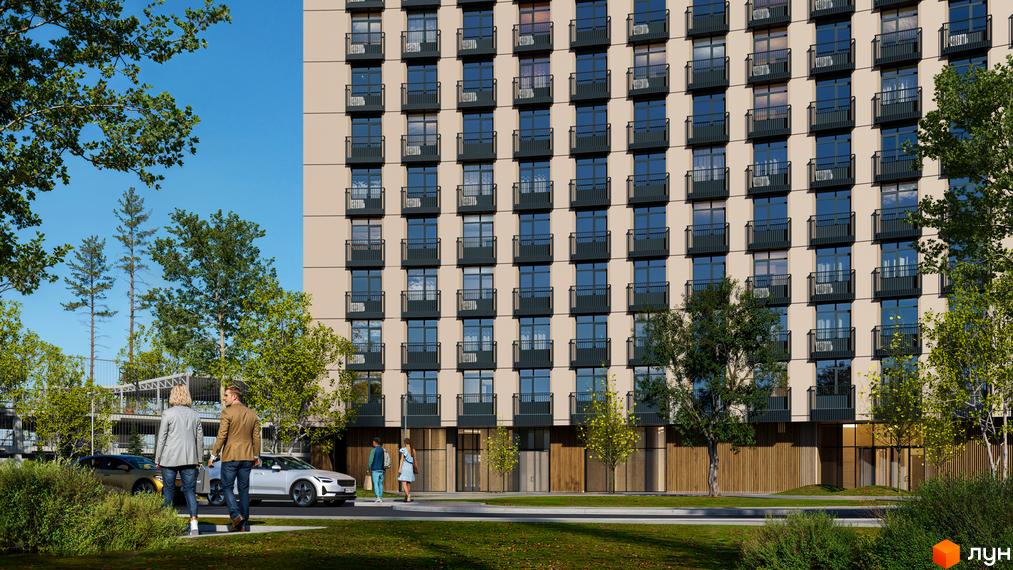 Фасад Житлового комплексу BEREG Residence з бежевими стінами та темними балконами. Навколо будинку зелені дерева, пішохідна зона та автомобілі.