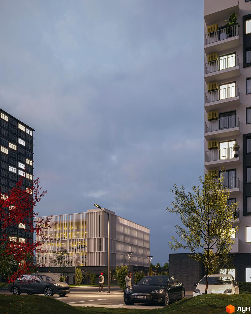 Зовнішній вигляд новобудови ЖК Авантаж 247 з фасадами, що освітлюються, та прибудинковою територією з деревами та автомобілями.