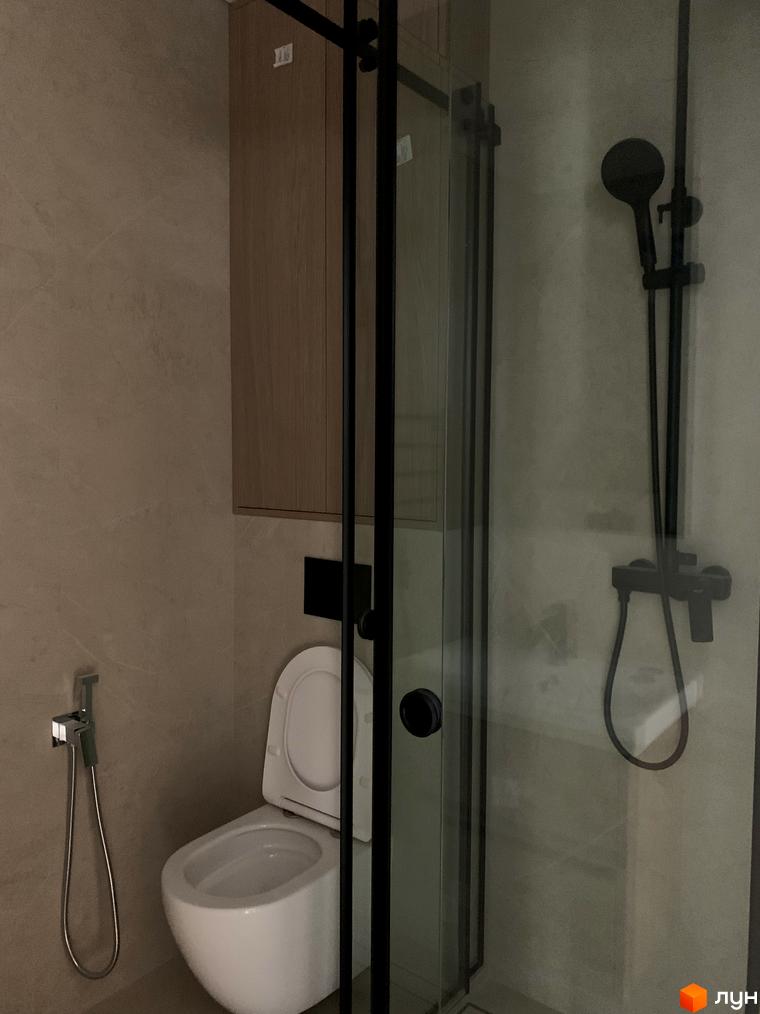 Сучасний дизайн ванної кімнати в новобудові ЖК Fine Flats з душовою кабіною, унітазом та біде. Оздоблення стін та меблів у натуральних тонах.