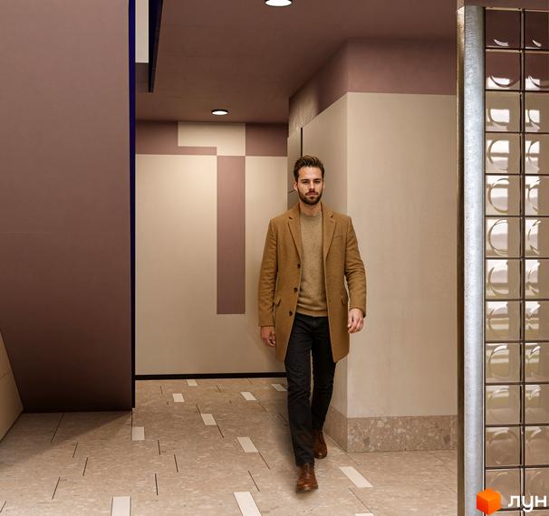 Просторий інтер'єр Житлового комплексу SOFIhome з геометричним дизайном стін та підлогою з террацо. Приміщення добре освітлене вбудованими світильниками.