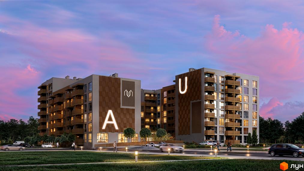 Житловий комплекс AUROOM DISTRICT ввечері. Два будинки з коричневими панелями, освітлені літери та зелена прибудинкова територія з дорогою.