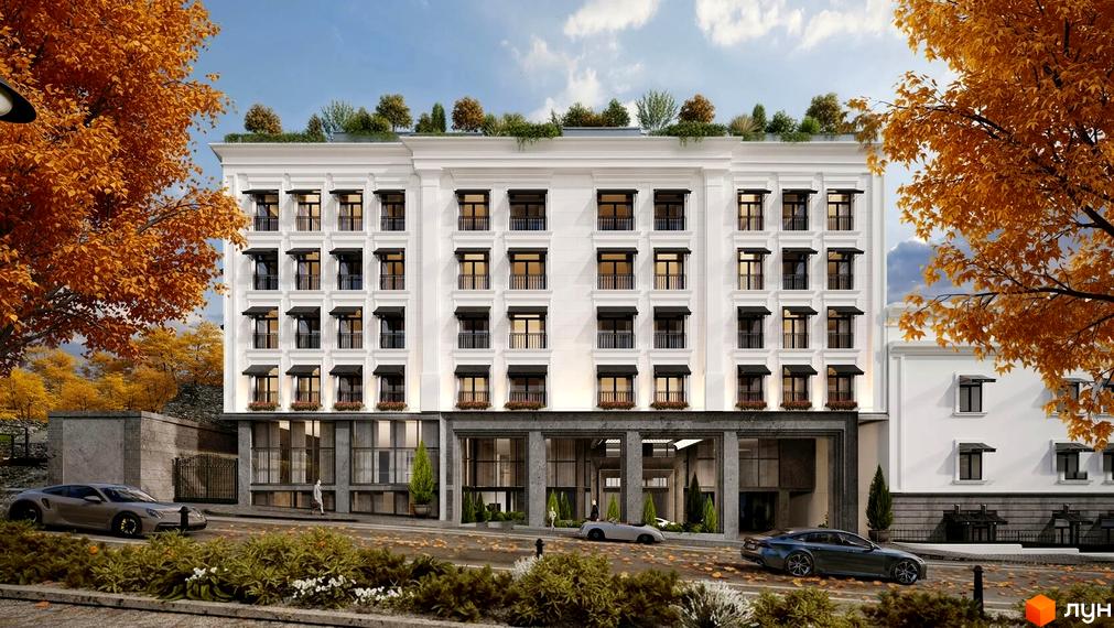 Білий фасад житлового комплексу MIY by Five Forces з чорними маркізами над вікнами та зеленим дахом. Навколо осінні дерева та дорога.