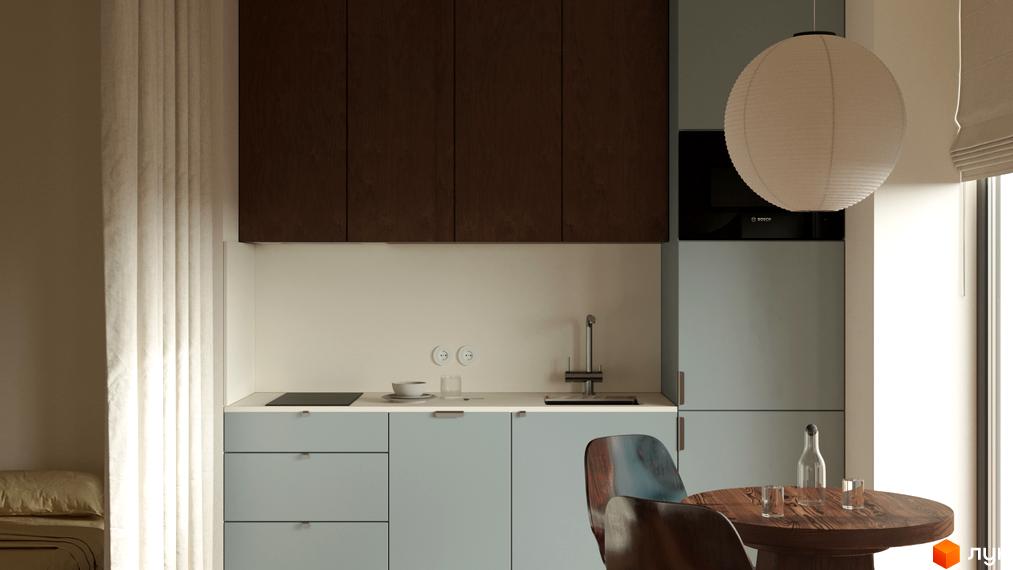 Інтер'єр кухні-вітальні в житловому комплексі З.40 з блакитними нижніми шафами, дерев'яним столом та білим підвісним світильником.