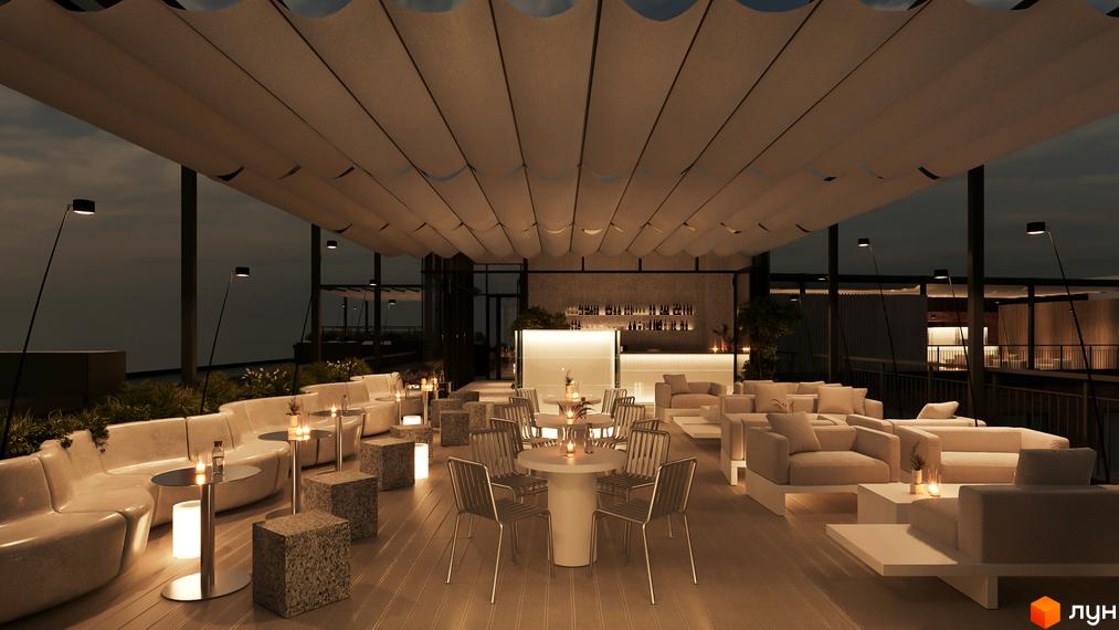 Сучасний бар на даху з м'якими диванами та столиками. Територія навколо бару озеленена та освітлена.
