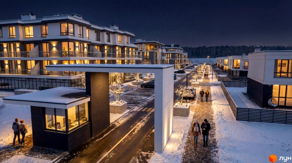 Котеджне містечко ParkWill вночі, з підсвіченими фасадами будинків та засніженою територією. Навколо будівель розташовані дерева та доріжки для пішоходів.