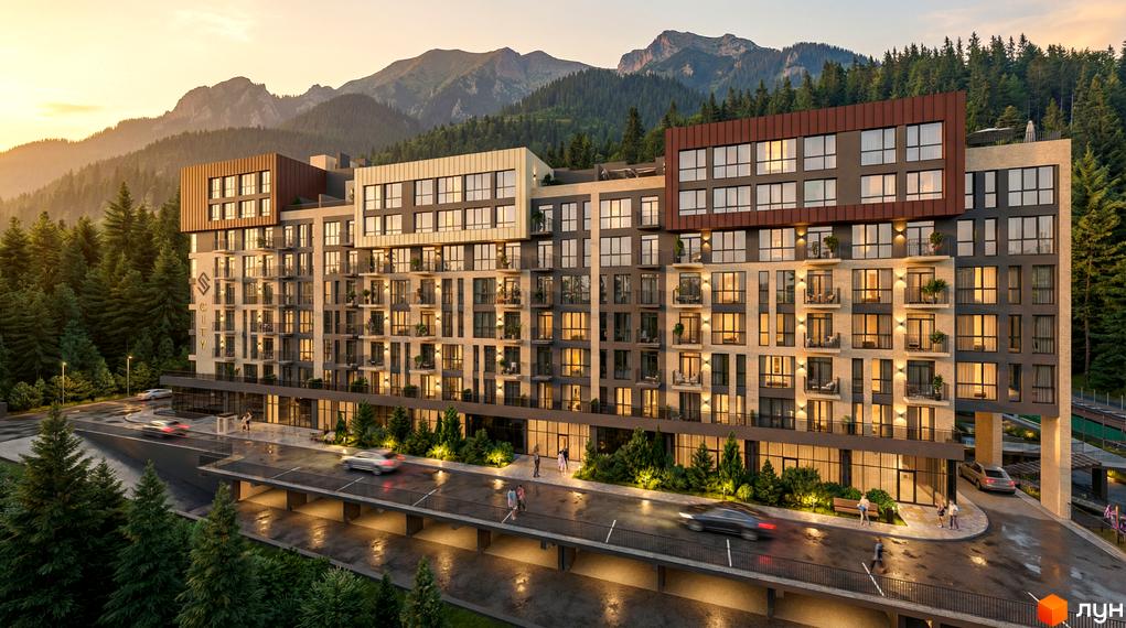 Новобудова Skogur City з фасадами з цегли та темних панелей, розташована серед хвойного лісу, з гірським пейзажем на фоні. Прибудинкова територія з освітленням та дорогою.