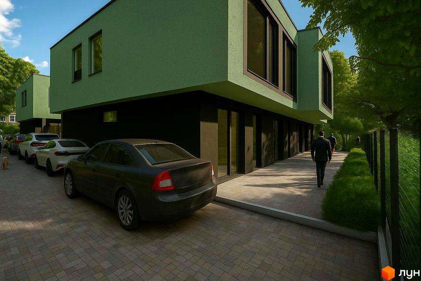 Зелені таунхауси Balance Houses з чорною нижньою частиною та великими вікнами. Поруч розташовані автомобілі та доглянута прибудинкова територія з деревами.