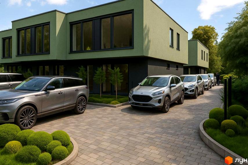 Зовнішній вигляд таунхаусів Balance Houses з зеленим фасадом та темними вікнами. Прибудинкова територія з бруківкою та доглянутими кущами.