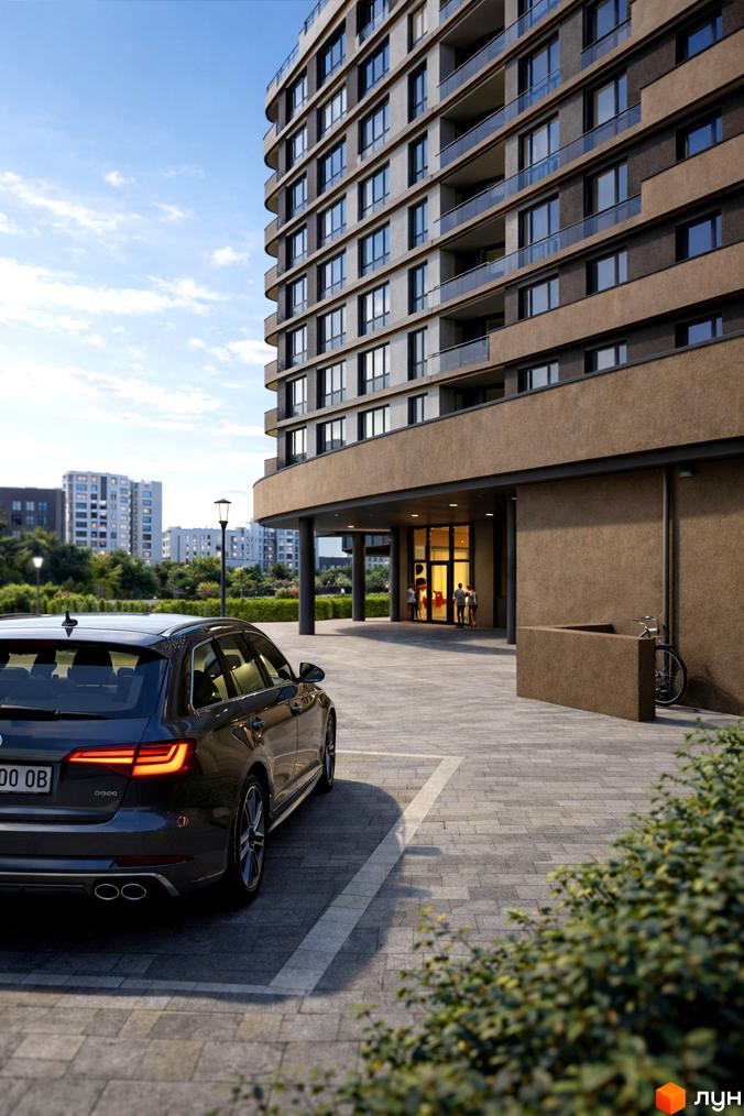 Зовнішній вигляд житлового комплексу Protezione з багатоповерховими будинками та прибудинковою територією з автомобілем та зеленими насадженнями.