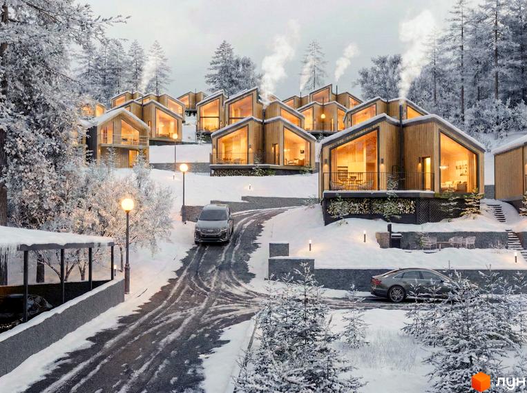 Котеджне містечко КМ Теплий у зимовому лісі, з дерев'яними будинками та великими вікнами, на тлі засніжених дерев та дороги з автомобілями.