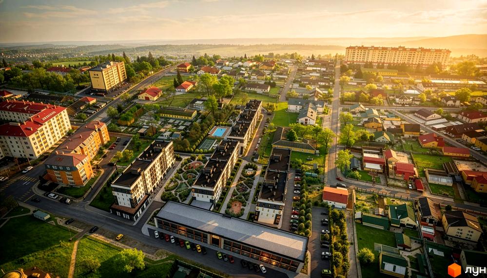 Житловий комплекс KLEN: багатоповерхові будинки з темними дахами та прибудинкова територія з зеленими насадженнями та доріжками.