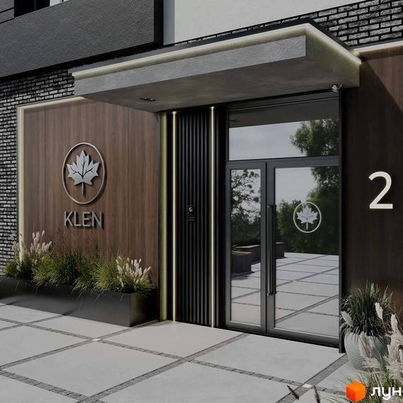 Вхідна група житлового комплексу KLEN з дерев'яною обшивкою та скляними дверима. Прибудинкова територія з доріжками та рослинністю.