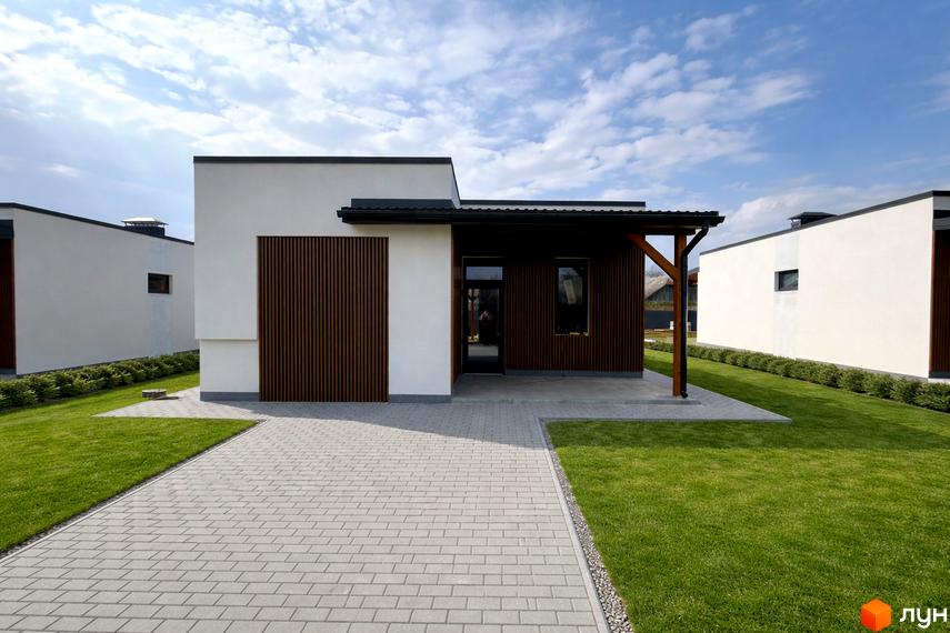 Котеджне містечко КМ Будиночок на Мрії: одноповерхові будинки з коричневими фасадами та білими стінами, доглянутий газон та бруківка.