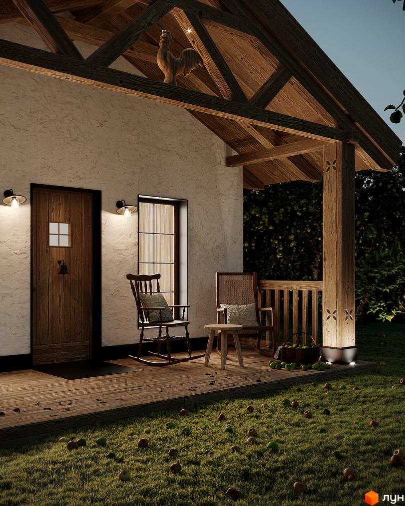 Котеджне містечко КМ ПАВЗА Village and Spa з дерев'яною верандою, дверима та вікном, оточене зеленню та яблуками на траві.